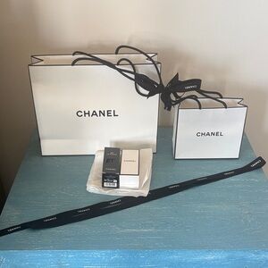 Chanel White bags , ribbons and boxes .